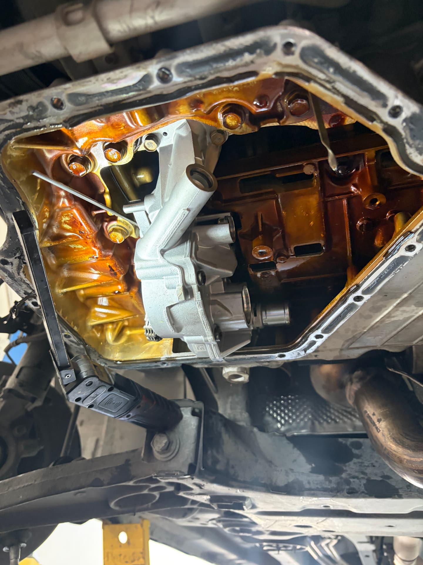 New oil pump installed inside the engine during an oil pan service at Johnny's Auto Repair in Victorville CA