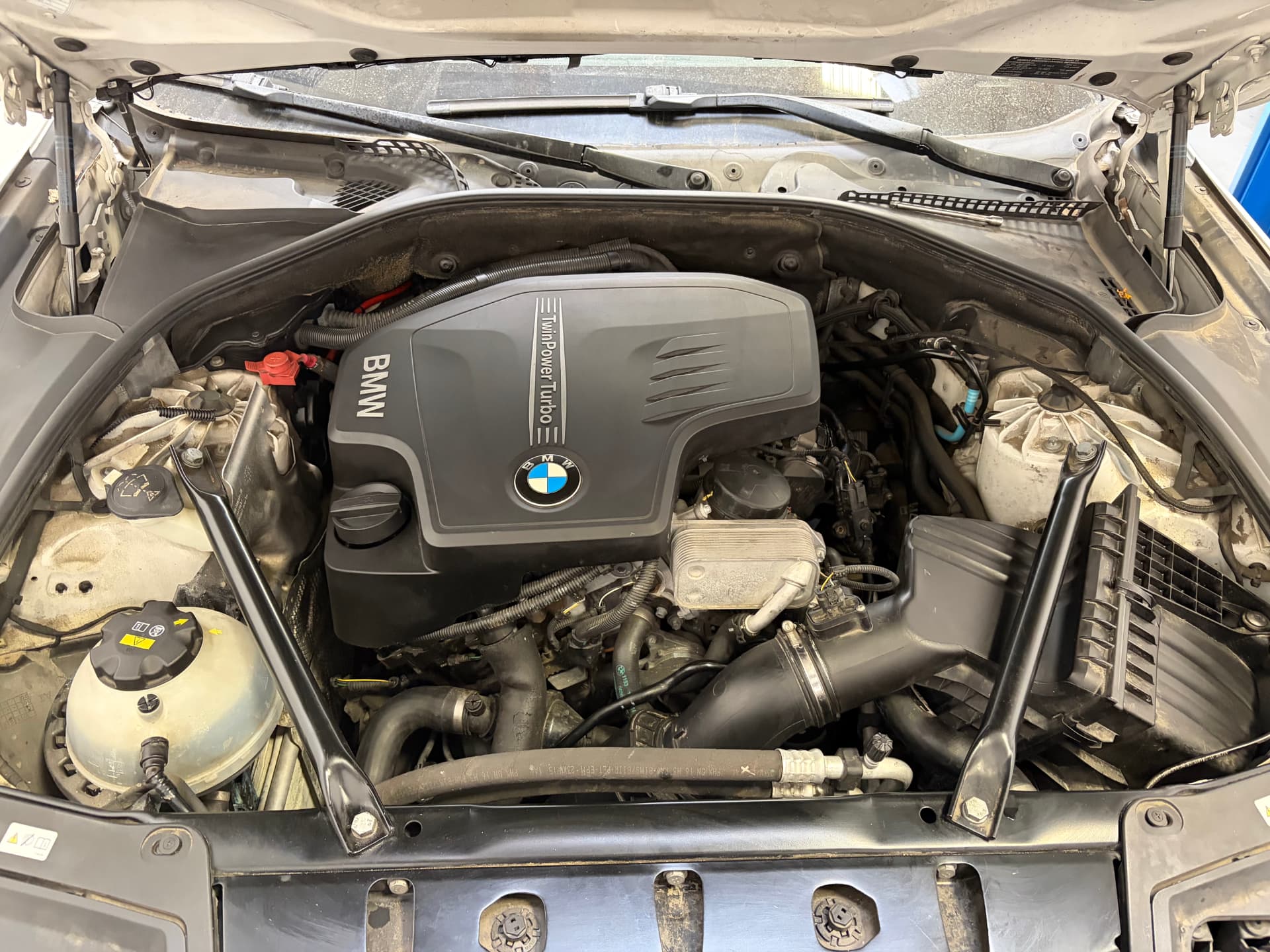 BMW TwinPower Turbo engine bay inspection at Johnny's Auto Repair on Ridgecrest Road in Victorville CA