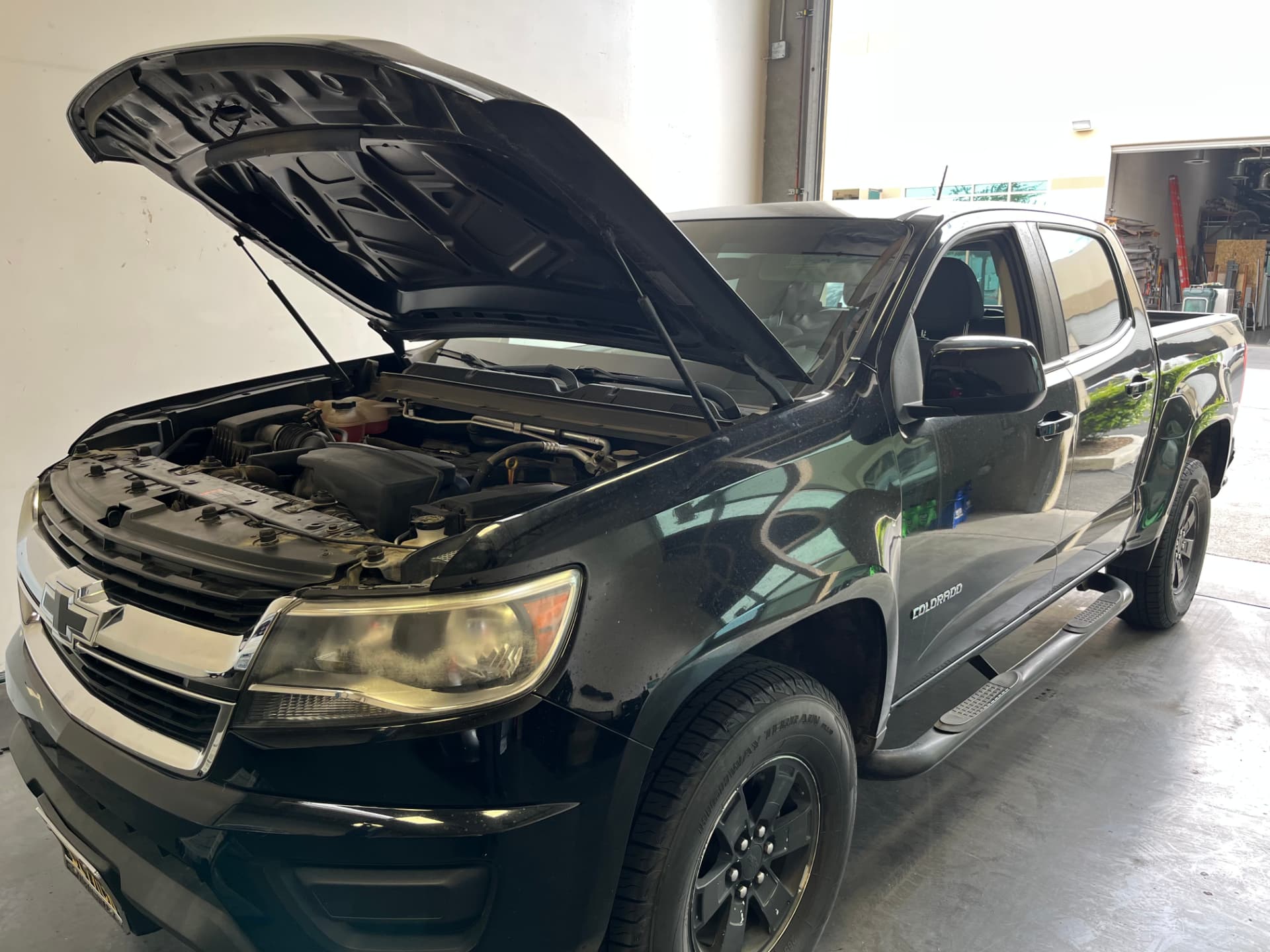 Chevrolet Colorado undergoing thermostat replacement at Johnny's Auto Repair near Spring Valley Lake in Victorville CA
